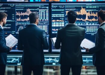 In a modern, high-tech trading floor environment, three financial professionals are deeply engaged in analyzing real-time stock market data displayed across several large screens. Each individual, clad in business attire, focuses intently on the fluctuating charts and graphs that depict various market trends and stock behaviors. They hold documents, likely containing additional detailed financial reports or historical data, which assist them in making informed decisions. The room is dimly lit, emphasizing the glowing screens and the serious, focused atmosphere of financial analysis and strategy.